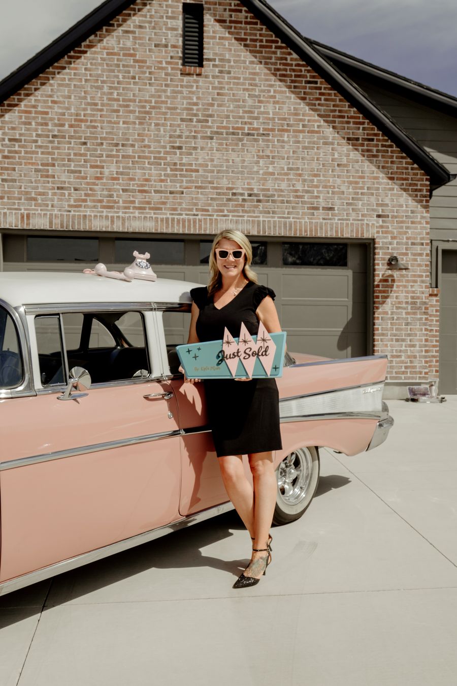 Kyla with a Just Sold sign beside Rosey